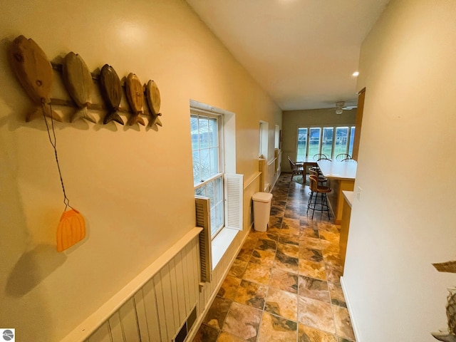 407 S Main St, Leland, MI 49654 - hall featuring stone finish flooring, healthy amount of natural light, recessed lighting, and lofted ceiling