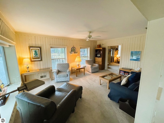 407 S Main St, Leland, MI 49654 - carpeted living room with a ceiling fan and wood walls