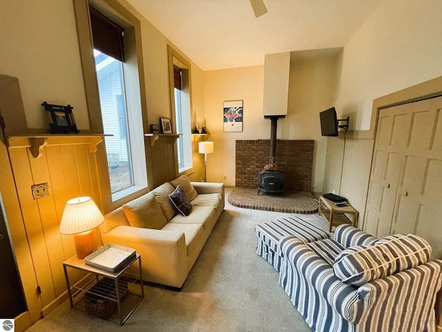 407 S Main St, Leland, MI 49654 - carpeted living room featuring a wood stove and a ceiling fan