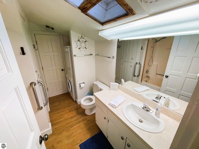 407 S Main St, Leland, MI 49654 - bathroom featuring vanity, wood finished floors, and  shower combination