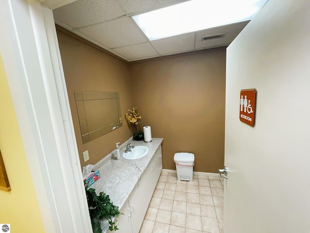 407 S Main St, Leland, MI 49654 - bathroom featuring vanity, a paneled ceiling, and tile patterned flooring
