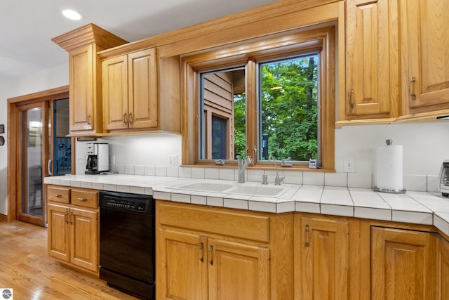 6352 S Westwood Pkwy, Suttons Bay, MI 49682 - kitchen featuring dishwasher, light wood-style floors, recessed lighting, and tile countertops