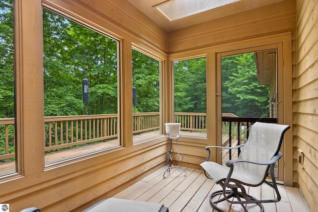 6352 S Westwood Pkwy, Suttons Bay, MI 49682 - sunroom / solarium with a skylight, wooden walls, and hardwood / wood-style floors