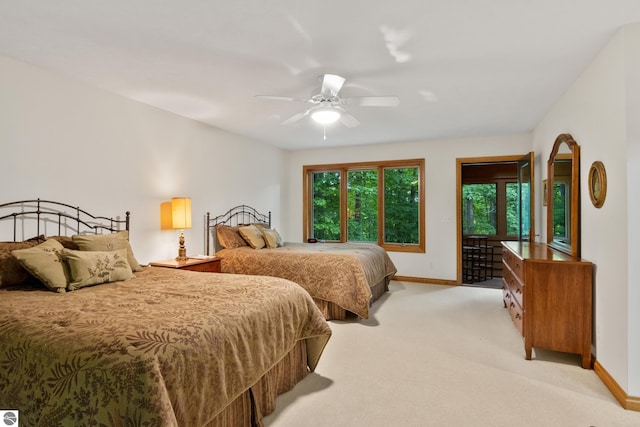 6352 S Westwood Pkwy, Suttons Bay, MI 49682 - bedroom with access to outside, light colored carpet, and ceiling fan