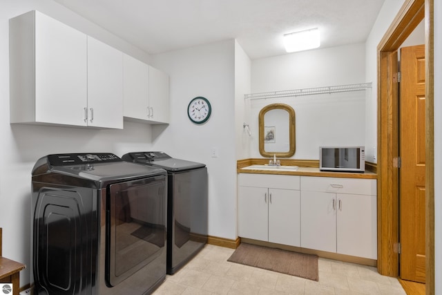 6352 S Westwood Pkwy, Suttons Bay, MI 49682 - laundry area featuring independent washer and dryer and cabinet space