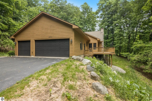 6352 S Westwood Pkwy, Suttons Bay, MI 49682 - view of front of house with a deck and a chimney