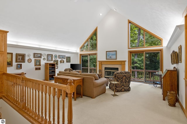 6352 S Westwood Pkwy, Suttons Bay, MI 49682 - carpeted living area featuring high vaulted ceiling, a fireplace, and plenty of natural light