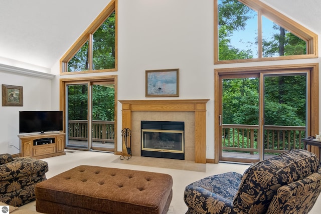 6352 S Westwood Pkwy, Suttons Bay, MI 49682 - carpeted living room with high vaulted ceiling, plenty of natural light, and a tiled fireplace