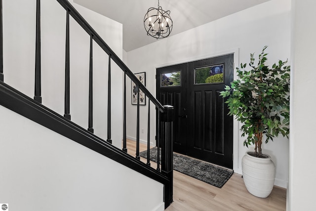 1259 Lin Dale Dr, Traverse City, MI 49686 - foyer featuring light wood-style floors, stairs, and a chandelier