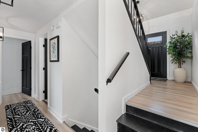 1259 Lin Dale Dr, Traverse City, MI 49686 - stairway featuring wood finished floors and baseboards