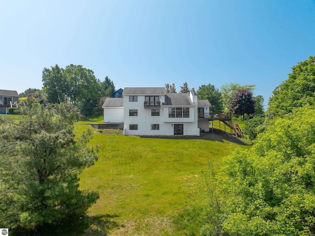 1259 Lin Dale Dr, Traverse City, MI 49686 - back of property with a yard, a deck, and a chimney