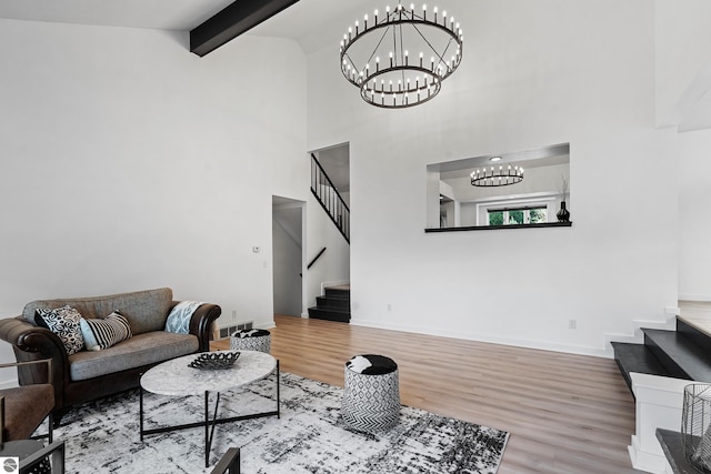 1259 Lin Dale Dr, Traverse City, MI 49686 - living room with stairs, wood finished floors, a chandelier, beamed ceiling, and high vaulted ceiling