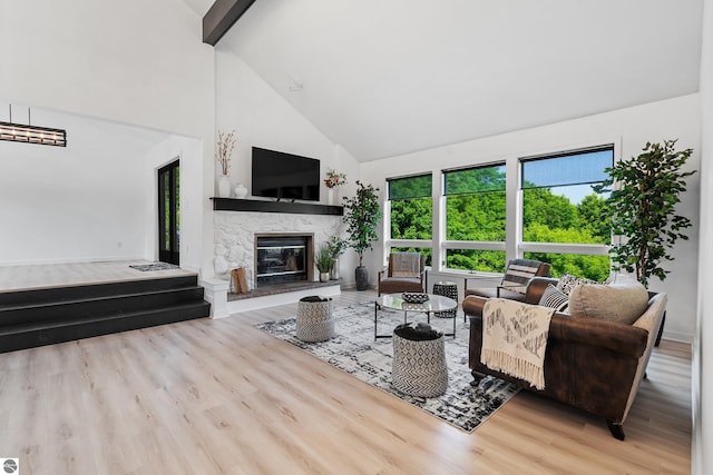 1259 Lin Dale Dr, Traverse City, MI 49686 - living room with high vaulted ceiling, a fireplace, wood finished floors, and beamed ceiling