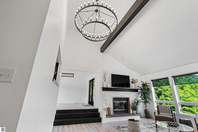 1259 Lin Dale Dr, Traverse City, MI 49686 - living area with high vaulted ceiling, wood finished floors, and a stone fireplace