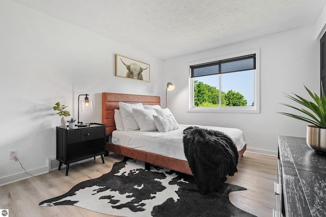 1259 Lin Dale Dr, Traverse City, MI 49686 - bedroom with light wood-style flooring and a textured ceiling