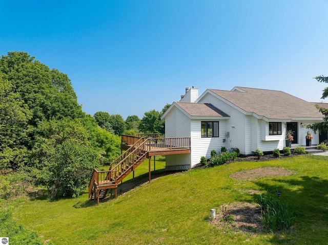 1259 Lin Dale Dr, Traverse City, MI 49686 - view of side of home featuring stairway, a deck, a chimney, a yard, and a shingled roof