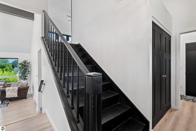 1259 Lin Dale Dr, Traverse City, MI 49686 - staircase featuring wood finished floors and a high ceiling