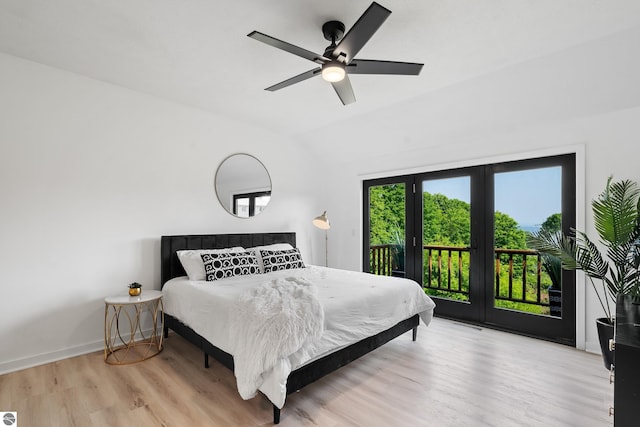 1259 Lin Dale Dr, Traverse City, MI 49686 - bedroom featuring access to exterior, light wood finished floors, vaulted ceiling, and a ceiling fan