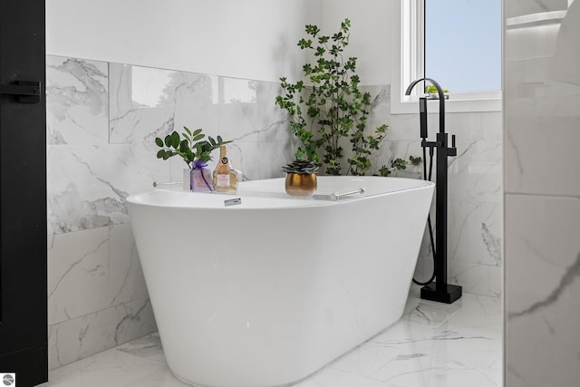 1259 Lin Dale Dr, Traverse City, MI 49686 - full bath featuring tile walls, a freestanding tub, marble finish floors, and stone wall