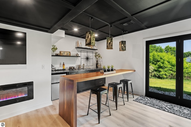 1259 Lin Dale Dr, Traverse City, MI 49686 - indoor wet bar featuring coffered ceiling, light wood-style floors, a glass covered fireplace, beamed ceiling, and fridge