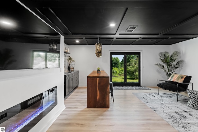1259 Lin Dale Dr, Traverse City, MI 49686 - bar area featuring light wood-style floors, a chandelier, and coffered ceiling