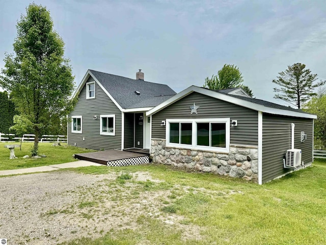 7160 Cherry Ave, Kewadin, MI 49648 - view of front facade featuring a deck, a chimney, stone siding, and roof with shingles