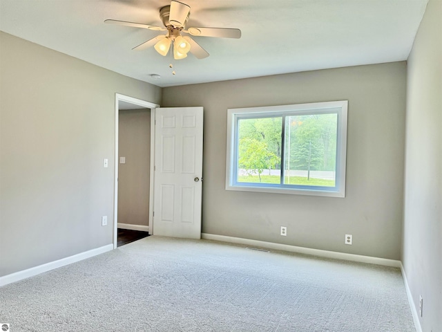 7160 Cherry Ave, Kewadin, MI 49648 - carpeted empty room with ceiling fan and a smoke detector