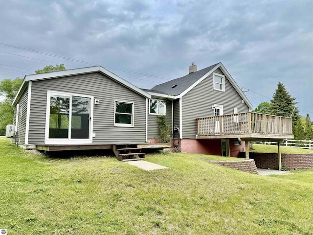 7160 Cherry Ave, Kewadin, MI 49648 - rear view of house featuring a wooden deck, a chimney, and a yard
