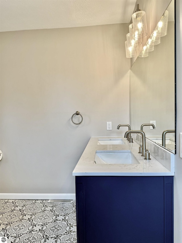7160 Cherry Ave, Kewadin, MI 49648 - bathroom featuring double vanity and tile patterned flooring