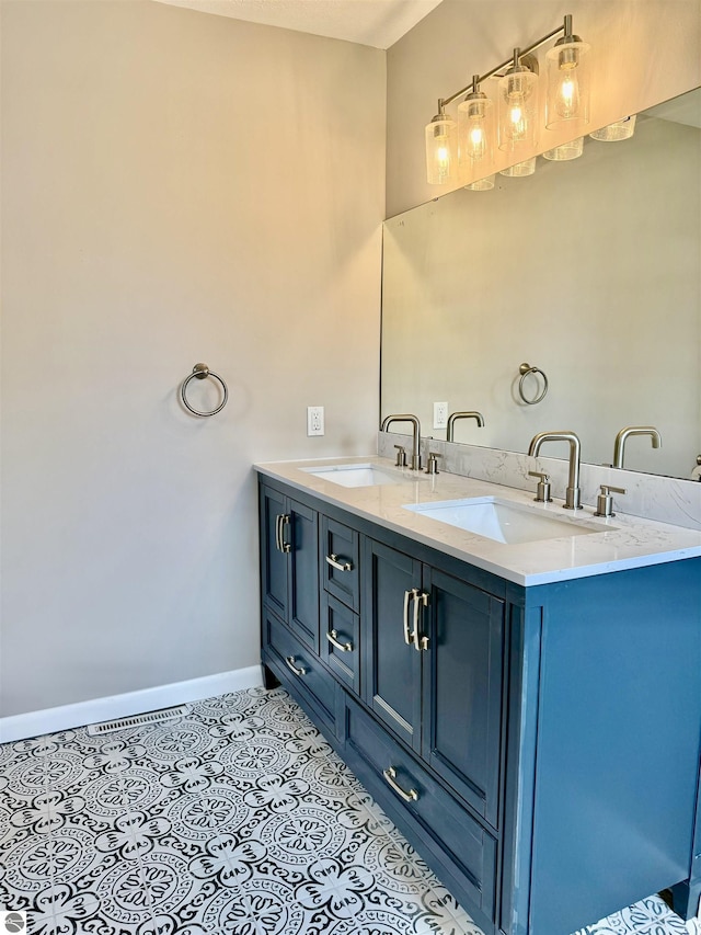 7160 Cherry Ave, Kewadin, MI 49648 - bathroom featuring double vanity and tile patterned flooring
