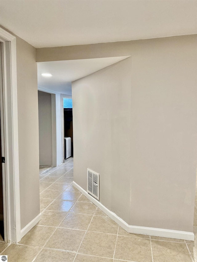 7160 Cherry Ave, Kewadin, MI 49648 - corridor featuring baseboards and light tile patterned flooring