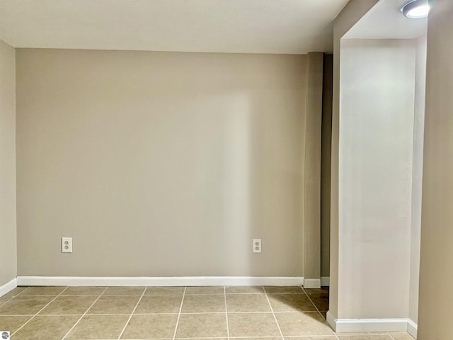 7160 Cherry Ave, Kewadin, MI 49648 - spare room with baseboards and light tile patterned floors