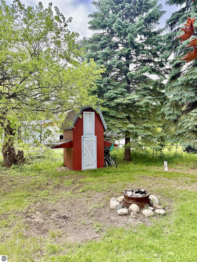 7160 Cherry Ave, Kewadin, MI 49648 - view of shed with a fire pit
