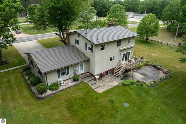 10200 S Lake Station Ave, Lake, MI 48632 - back of house featuring a wooden deck, a patio area, a chimney, and a lawn