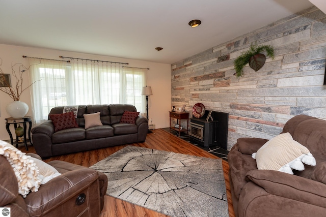 10200 S Lake Station Ave, Lake, MI 48632 - living room with wood finished floors, a wood stove, and a baseboard radiator