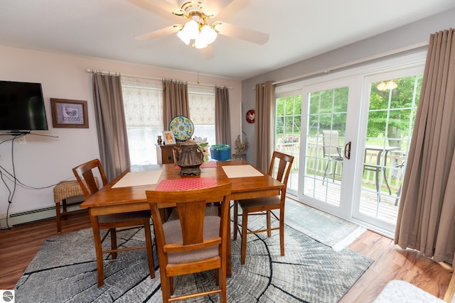 10200 S Lake Station Ave, Lake, MI 48632 - dining room featuring light wood-style flooring, a ceiling fan, and a baseboard heating unit