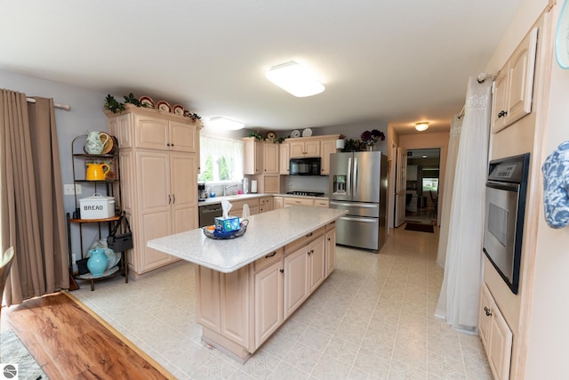 10200 S Lake Station Ave, Lake, MI 48632 - kitchen featuring stainless steel appliances, light countertops, and a kitchen island