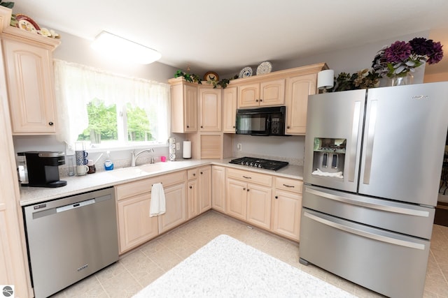 10200 S Lake Station Ave, Lake, MI 48632 - kitchen with appliances with stainless steel finishes, light countertops, light brown cabinetry, and light tile patterned floors