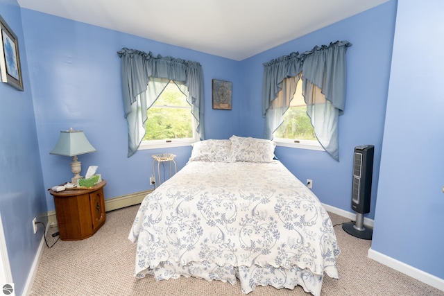 10200 S Lake Station Ave, Lake, MI 48632 - carpeted bedroom featuring a baseboard heating unit and baseboards
