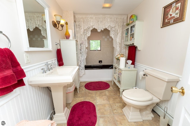 10200 S Lake Station Ave, Lake, MI 48632 - bathroom featuring a baseboard heating unit, a wainscoted wall, a decorative wall, tile patterned flooring, and shower / tub combo with curtain