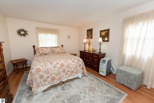 10200 S Lake Station Ave, Lake, MI 48632 - bedroom with light wood-type flooring and a baseboard radiator