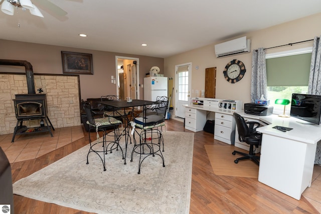 10200 S Lake Station Ave, Lake, MI 48632 - dining room featuring a wall mounted air conditioner, recessed lighting, a ceiling fan, a wood stove, and an office area