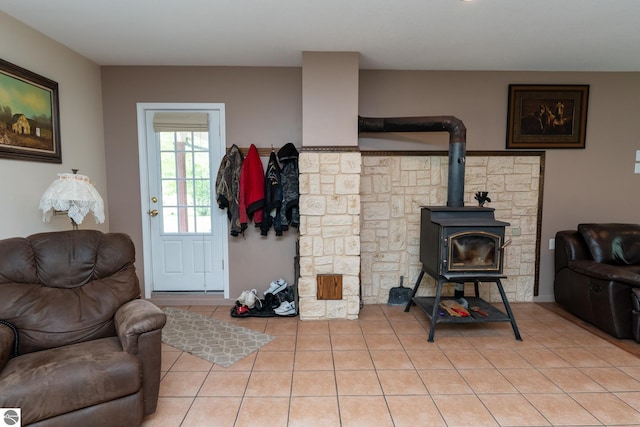 10200 S Lake Station Ave, Lake, MI 48632 - living area featuring light tile patterned flooring and a wood stove
