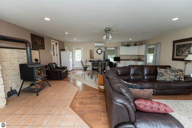 10200 S Lake Station Ave, Lake, MI 48632 - living area with a ceiling fan, recessed lighting, light tile patterned flooring, and a wood stove