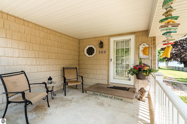 589 Pine Ln, East Tawas, MI 48730 - doorway to property featuring a porch