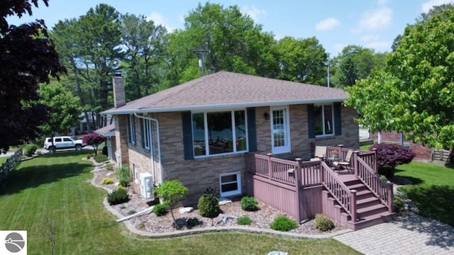 589 Pine Ln, East Tawas, MI 48730 - single story home featuring a chimney, a front yard, and a deck