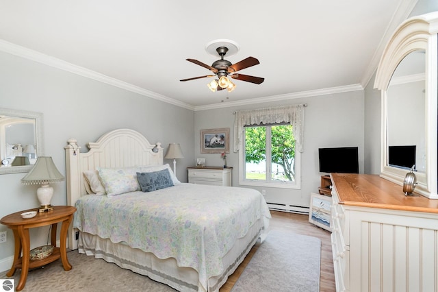 589 Pine Ln, East Tawas, MI 48730 - bedroom featuring crown molding, baseboard heating, light wood-style floors, and ceiling fan