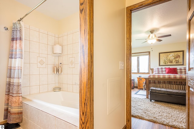 6375 S Isabella Rd, Shepherd, MI 48883 - bathroom with wood finished floors, ceiling fan, and tiled shower / bath