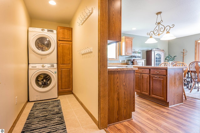 6375 S Isabella Rd, Shepherd, MI 48883 - laundry room with stacked washer and clothes dryer and recessed lighting