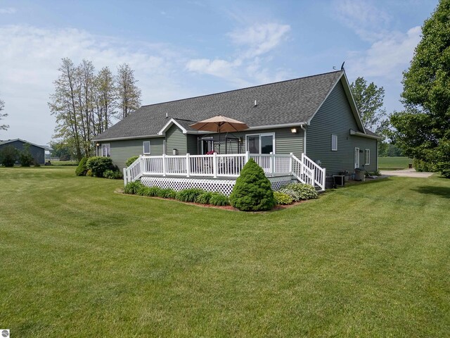6375 S Isabella Rd, Shepherd, MI 48883 - back of house with roof with shingles, a wooden deck, and a lawn
